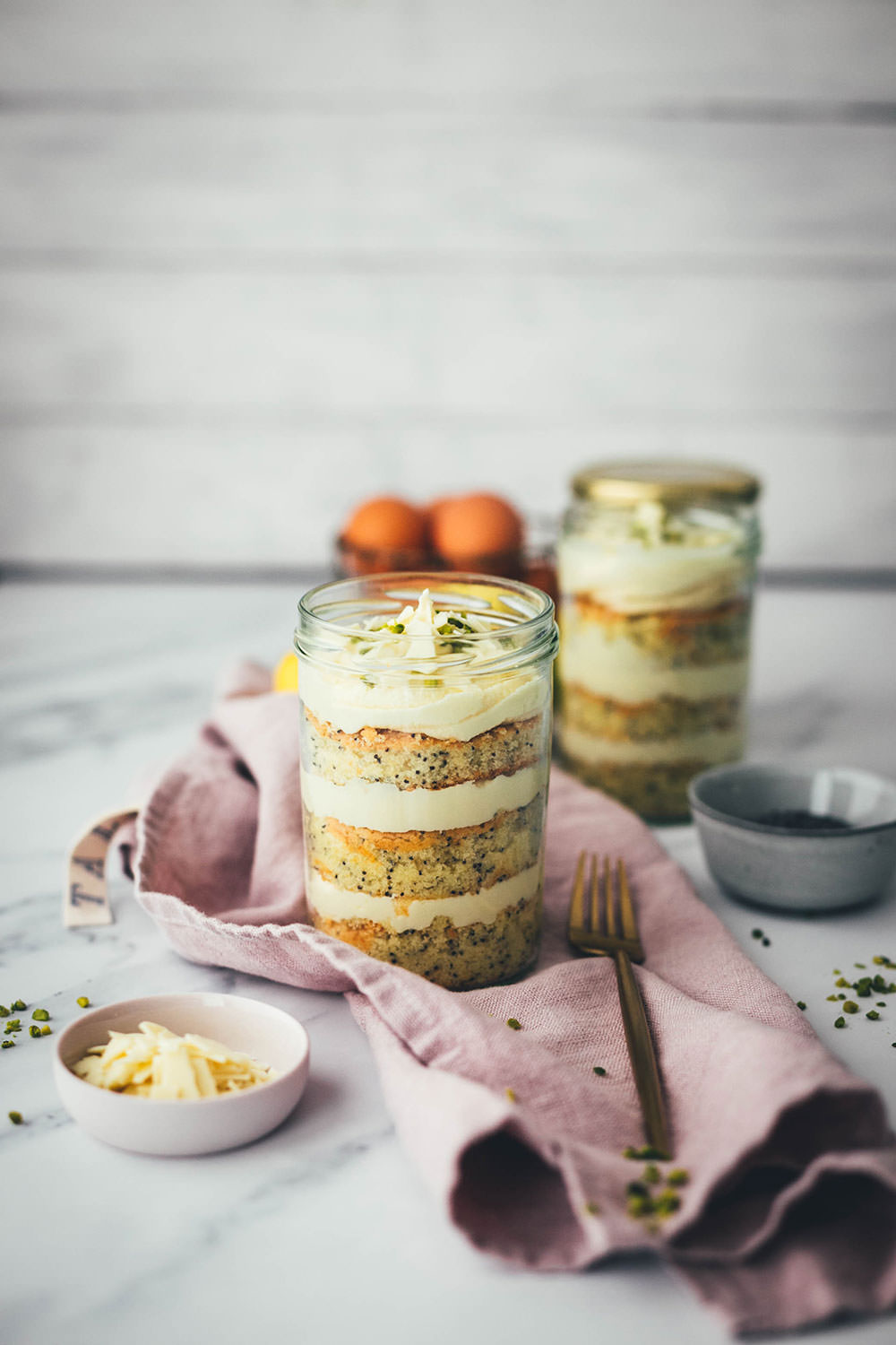 Entzückende Zitronen-Mohn-Törtchen mit weißer Schokoladen-Ganache – als kleine Torte im Einmachglas geschichtet und damit perfekt zum Mitnehmen und Verschenken! Saftiger Rührkuchen wird auf dem Blech gebacken, ausgestochen und abwechselnd mit einer leckeren Schoko-Ganache ins Glas drapiert. Gut verschlossen halten die kleinen Törtchen ein paar Tage im Kühlschrank. Auch perfekt für das Picknick draußen oder einen Spaziergang, zum Beispiel als Geburtstagstorte für eine Person oder einen anderen schönen Anlass. Es gibt immer einen Grund zu feiern! | moeyskitchen.com
