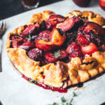 Rezept für leckere Pflaumen-Crostata – das ist ein wunderbar knuspriger Pflaumenkuchen, als rustikale Galette gebacken und mit Thymian verfeinert. Mit frischen Pflaumen, Mirabellen oder Zwetschgen perfekt für den Spätsommer. Die Tarte braucht nur wenig Zucker und schmeckt dann köstlich zu Schlagsahne oder Vanilleeis! | moeyskitchen.com
