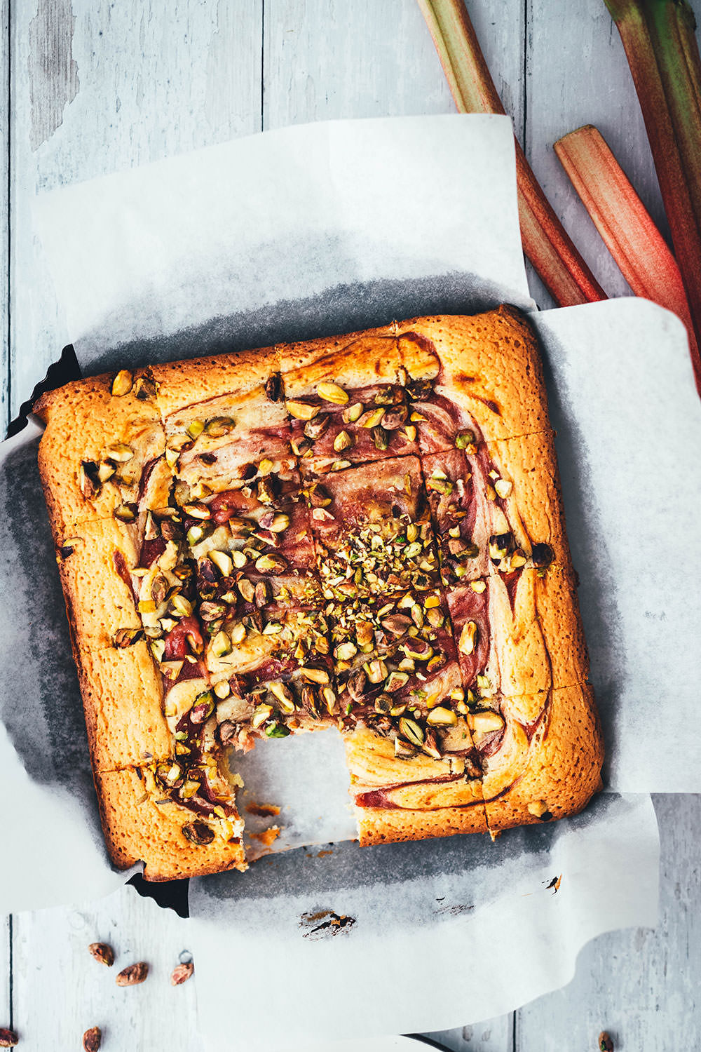 Jetzt ist die perfekte Zeit für leckeren Rhabarber-Kuchen gekommen. Hier gibt es heute deswegen eine neue Rezeptidee von mir: saftige Rhabarber-Blondies, die mit weißer Schokolade und knackigen Pistazien gebacken werden. Der Rhabarber wandert püriert und ohne Stückchen in die Blondies. So sorgt er nicht nur für einen hübschen Swirl, sondern schmeckt auch den Menschen, die sonst nicht die größten Rhabarber-Fans sind. | moeyskitchen.com