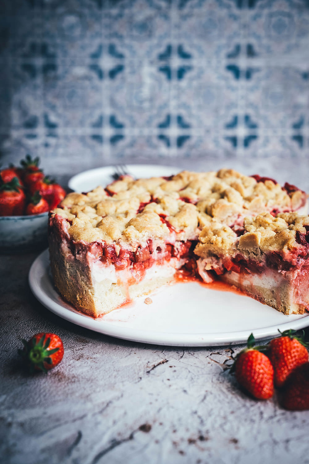Rezept für einen super saftigen Erdbeer-Rhabarber-Kuchen mit einem selbst gekochten Vanillepudding als Cremeschicht und getoppt mit knusprigen Butter-Streuseln. Der perfekte Streuselkuchen für den Frühling und Sommer. Süße Erdbeeren treffen auf säuerlichen Rhabarber und cremigen Pudding. Dazu gibt es einen einfachen Rührteig-Boden und ein leckeres Streusel-Topping. | moeyskitchen.com