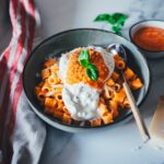 Rezept für cremiges Pesto Calabrese mit gerösteter Paprika, Tomaten, Ricotta und Parmesan – schnell im Airfryer zubereitet. Ideal als Pastasauce, Dip oder Brotaufstrich. Hier mit Pasta und Burrata serviert. | moeyskitchen.com